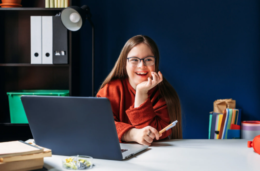 Young lady with disability working on laptop